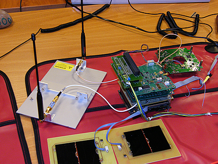 Showing the PA and RF Boards, the test antennas in their jig, two test solar panels, and the ANTS Showing the PA and RF Boards, the test antennas in their jig, two test solar panels, and the ANTS