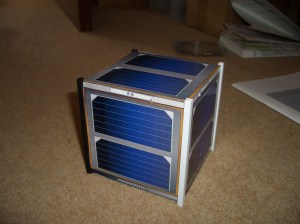 FUNcube model close up. You can see the RBF plug at the bottom left, and one of the antennas deployer openings at the top left. FUNcube model close up. You can see the RBF plug at the bottom left, and one of the antennas deployer openings at the top left.